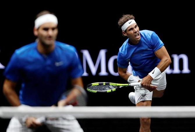 Rafael Nadal serves during the doubles match