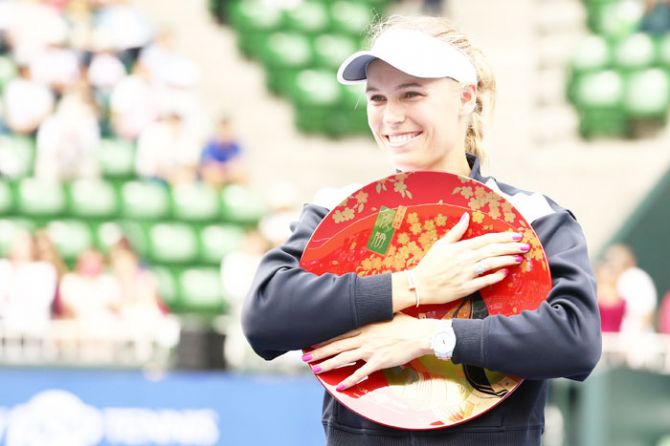 Denmark's Caroline Wozniacki with the Toray Pan Pacific Open Tennis title after defeating Russia's Anastasia Pavlyuchenkova in the final at the At Ariake Coliseum in Tokyo on Sunday