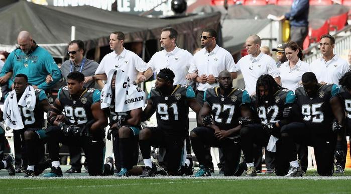 Shad Khan joins Jaguars and Ravens players in pregame protest and