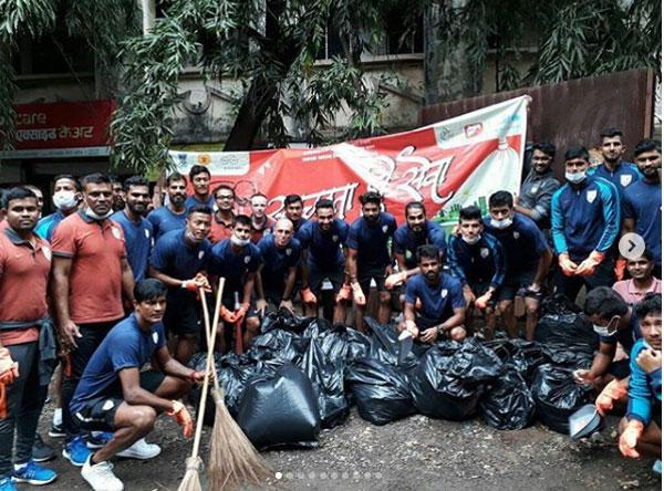 The Indian football team and support staff pose after completing their task for the evening