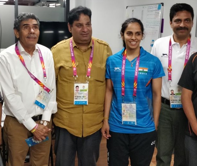  Saina Nehwal with her father, Harvir Singh, left, and officals