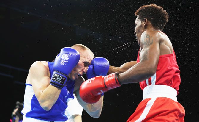 Seychelle's Edrian Volcree throws a punch at New Zealand's Richard Hadlow during their bout at Oxenford Studios