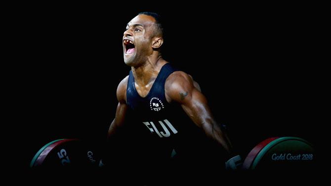 Fiji’s Manueli Tulo competes during the Weightlifting Men's 56kg Final at Carrara Sports and Leisure Centre