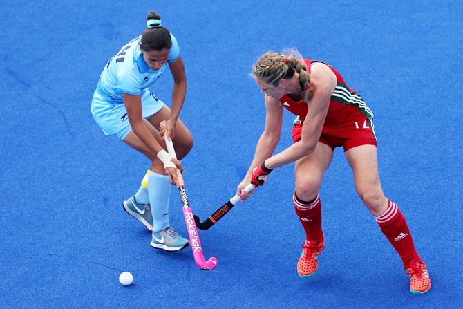 India's Rani Rampal tries to make her way past Tina Evans of Wales