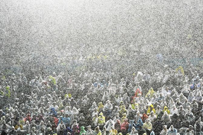 The crowd brave the torrential rain at Optus Aquatic Centre 