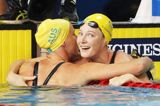 Australia's Cate Campbell and Bronte Campbell hug after the women's 50m freestyle final at Optus Aquatic Centre