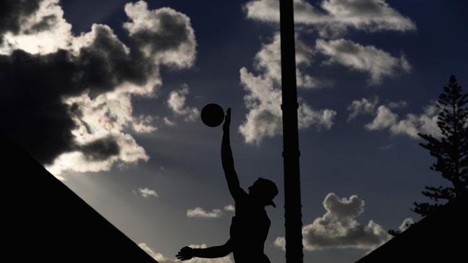 England's Chris Gregory serves against Cyprus' Dimitris Apostolou and Georgios Chrysostomou during their men's beach volleyball preliminary round match at Coolangatta Beachfront