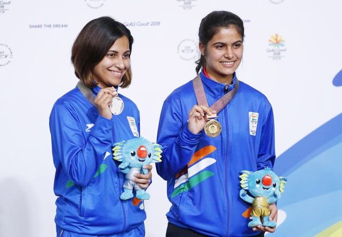 Manu Bhaker, right, and Heena Sidhu pose with their medals after winning gold and silver in the women's 10 metre Air Pistol at the Gold Coast Commonwealth Games.
