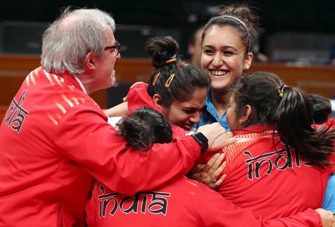 Members of team India celebrate after winning a gold medal