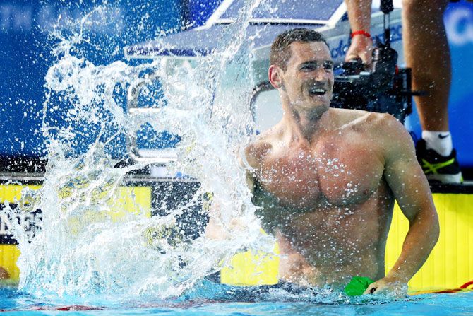 South Africa's Cameron van der Burgh celebrates victory in the men's 50m breaststroke final at Optus Aquatic Centre on Monday
