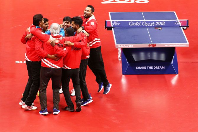 India's Table Tennis team celebrate after defeating Nigeria to win the gold medal at Oxenford Studios on Monday
