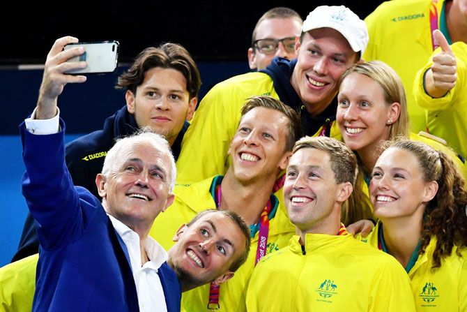 Australia Prime Minister Malcolm Turnbull takes a selfie with members of the Australia swimming team at Optus Aquatic Centre on Tuesday