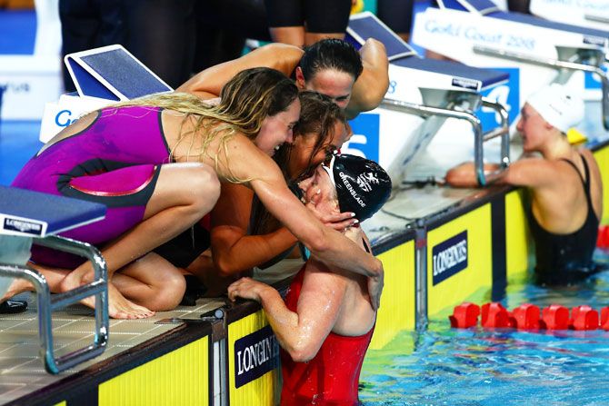 Georgia Davies, Chloe Tutton, Alys Thomas and Kathryn Greenslade of Wales celebrate bronze in the Women's 4 x 100m medley relay final at Optus Aquatic Centre on Tuesday