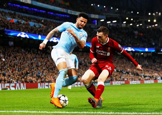 Manchester City's Kyle Walker in action with Liverpool's Andrew Robertson 