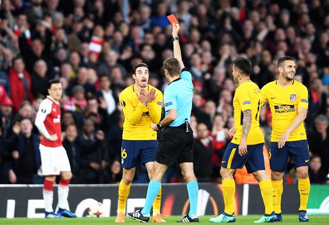 Atletico Madrid's Sime Vrsaljko is shown a red card