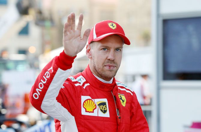 Ferrari's Sebastian Vettel celebrates the pole position