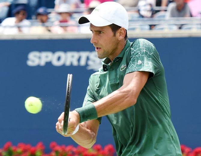 Serbia's Novak Djokovic plays a shot against Bosnia's Mirza Basic in the Rogers Cup tennis tournament at Aviva Centre in Toronto on Wednesday