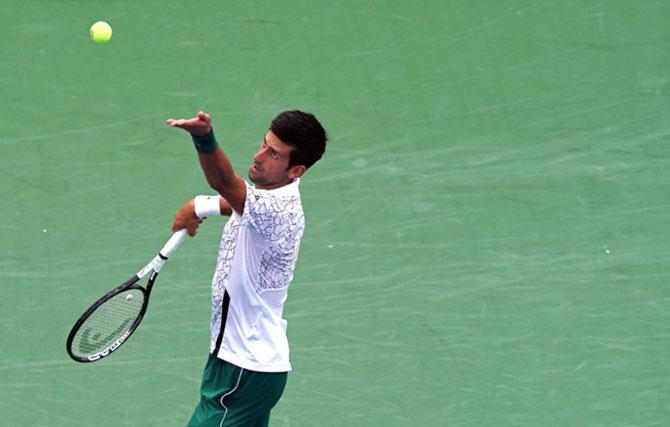 Serbia's Novak Djokovic serves against France's Adrian Mannarino in the Western and Southern Tennis Open at Lindner Family Tennis Center in Mason, Ohia, on Wednesday