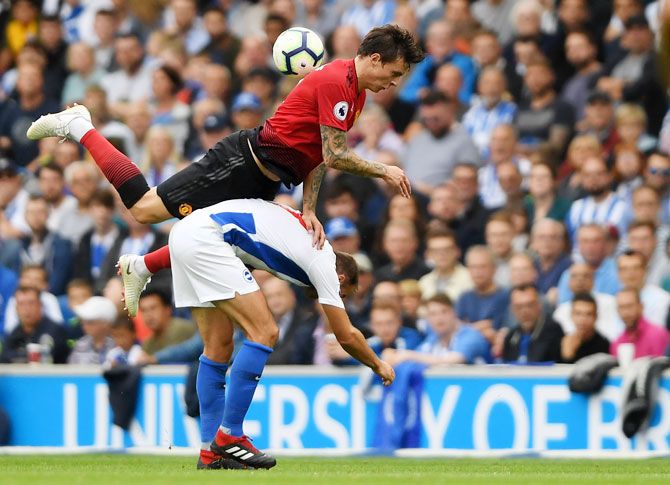 Manchester United's Victor Lindelof collides with Brighton and Hove Albion's Glenn Murray