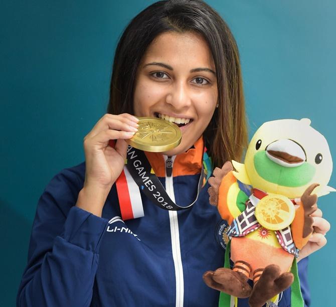 Heena Sidhu shows off her bronze medal on the podium at the Asian Games on Friday