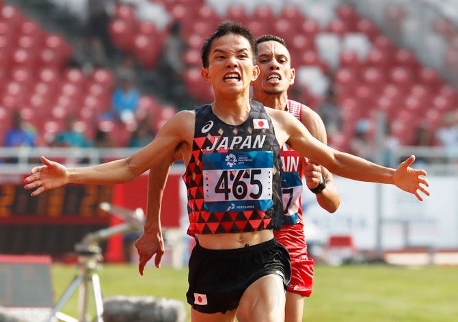 Japan's Hiroto Inoue reacts after finishing the men's marathon final at the Asian Games on Saturday