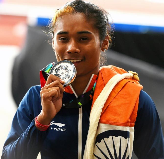 Hima Das celebrates winning the silver medal in the women's 400m at the Asian Games