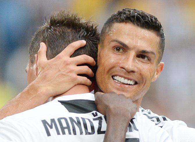 Juventus' Mario Mandzukic celebrates scoring their second goal with Cristiano Ronaldo during their Serie A match against Lazio at the Allianz Stadium in Turin on Saturday