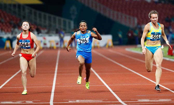 China's Liang Xiaojing, India's Dutee Chand and Kazakhstan's Olga Safronova compete in the Women's 100m Semi-final at the Asian Games