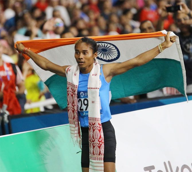 Hima Das celebrates after winning the silver at the Asian Games on Sunday