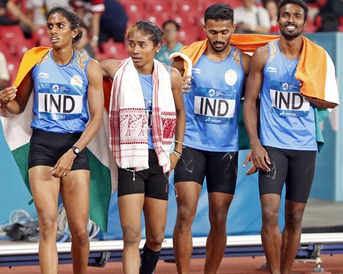  Muhammed Anas Yahiya, Hima Das, Poovamma Raju Machettira and Arokia Rajiv of India celebrate after the finish