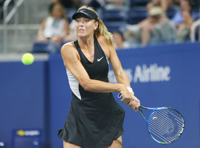 Russia's Maria Sharapova plays a return against Switzerland's Patty Schnyder in a first round match of the 2018 US Open at USTA Billie Jean King National Tennis Center on Tuesday