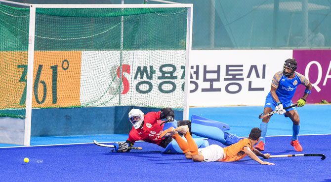 India's captain and goalkeeper Sreejesh saves a goal during the Asian Games hockey semi-final match against Malaysia