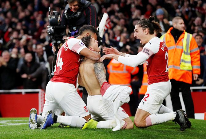 Arsenal's Lucas Torreira celebrates with teammates after scoring their fourth goal 