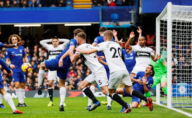 Chelsea's Marcos Alonso clears the ball from the Chelsea penalty area during a goalmouth melee 