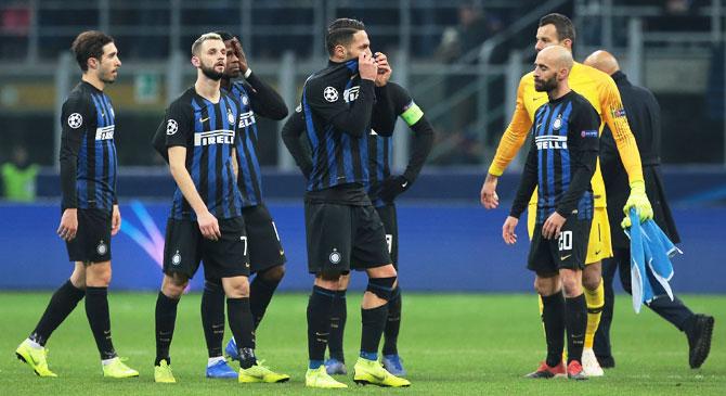 Inter Milan players wear a dejected look after their loss to PSV at San Siro in Milan