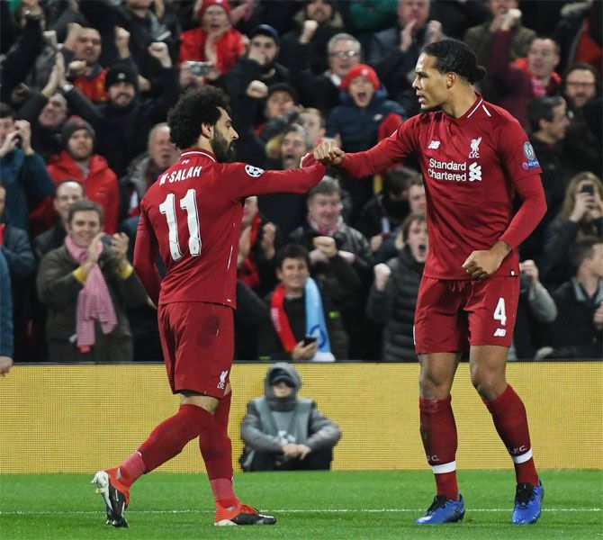 Liverpool's Mo Salah celebrates with Virgil van Dyke after scoring against Napoli on Tuesday