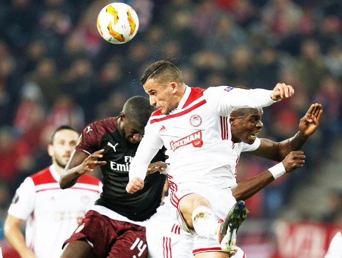 Olympiacos' Omar Elabdellaoui in action with AC Milan's Tiemoue Bakayoko during their Group F match at Karaiskakis Stadium in Piraeus, Greece, on Thursday