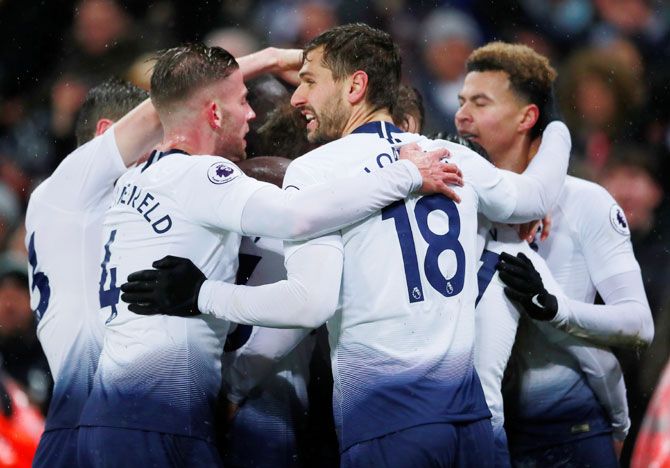 Tottenham's Christian Eriksen (hidden) celebrates with team mates after scoring their first goal against Burnley on Saturday