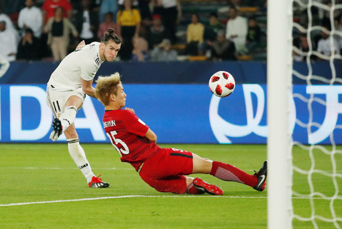 Real Madrid's Gareth Bale scores their third goal against Kashima Antlers to complete his hat-trick in the Club World Cup semi-final at Zayed Sports City Stadium in Abu Dhabi on Wednesday