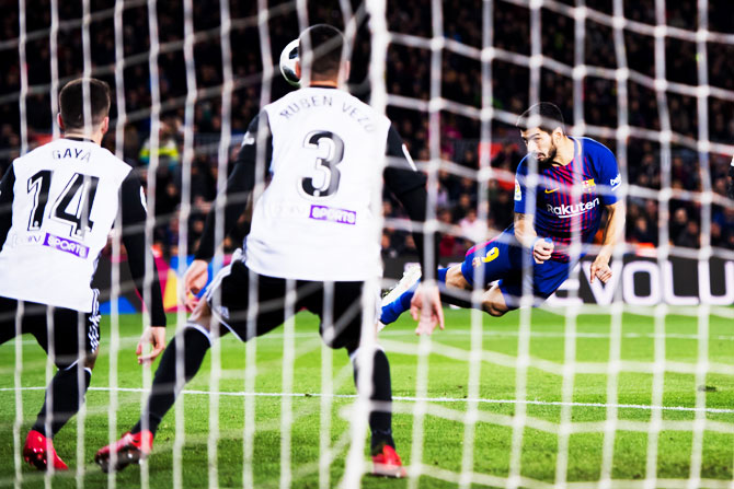 FC Barcelona's Luis Suarez scores the opening goal during the Copa del Rey semi-final first leg match against Valencia CF at Camp Nou in Barcelona on Thursday