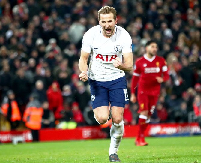Liverpool's Mohamed Salah scores their second goalTottenham Hotspur's Harry Kane celebrates after scoring the equaliser and his 100th Premier League goal at Anfield on Sunday