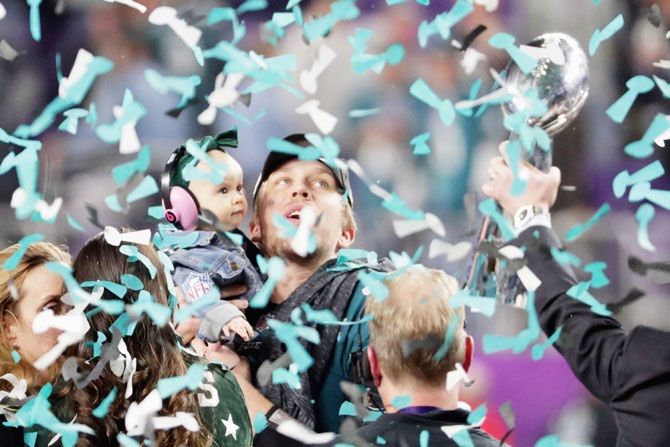 Nick Foles #9 of the Philadelphia Eagles celebrates with his daughter Lily Foles after his tean's 41-33 victory over the New England Patriots in Super Bowl LII final at US Bank Stadium in Minneapolis, Minnesota on Sunday
