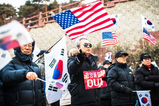 Anti-North Korea protesters demonstrate against a performance by North Korea's Samjiyon art troupe at Gangneung Art Centre in Gangneung, South Korea on Thursday