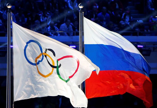 The Russian national flag (R) and the Olympic flag 