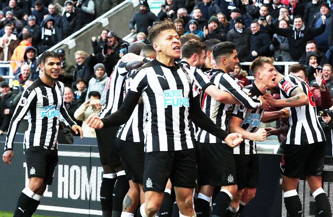 Newcastle United's Matt Ritchie celebrates with teammates after scoring against Manchester United at St James' Park in Newcastle on Sunday
