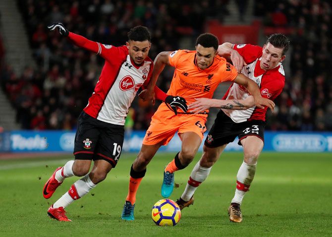 Liverpool's Trent Alexander-Arnold and Southampton's Sofiane Boufal and Pierre-Emile Hojbjerg vie for possession