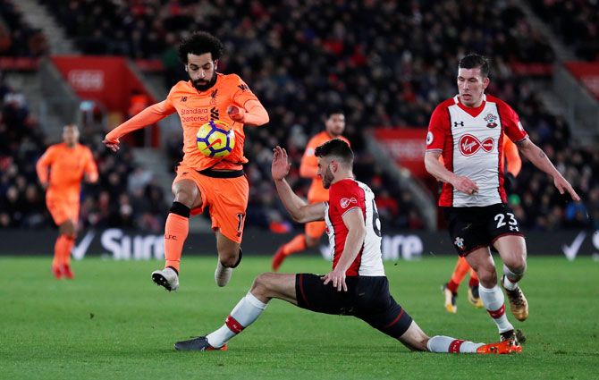 Liverpool's Mohamed Salah in challenged by Southampton's Wesley Hoedt 