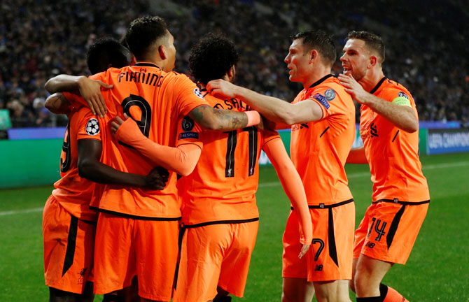 Liverpool players celebrate the third goal scored by teammate Sadio Mane