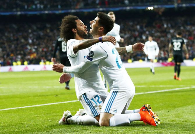 Real Madrid's Marcelo celebrates scoring the 3rd with Marco Asensio during their UEFA Champions League Round of 16 first leg match against Paris Saint-Germain at Santiago Bernabeu in Madrid on Wednesday