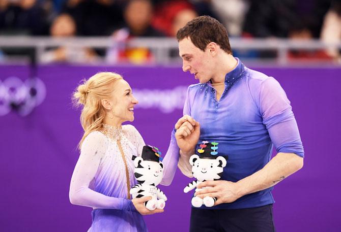 Gold medal winners Aljona Savchenko and Bruno Massot of Germany celebrate on the podium